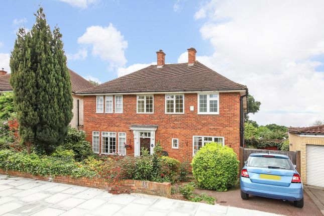 A large house with a car parked in front, showing a spacious driveway