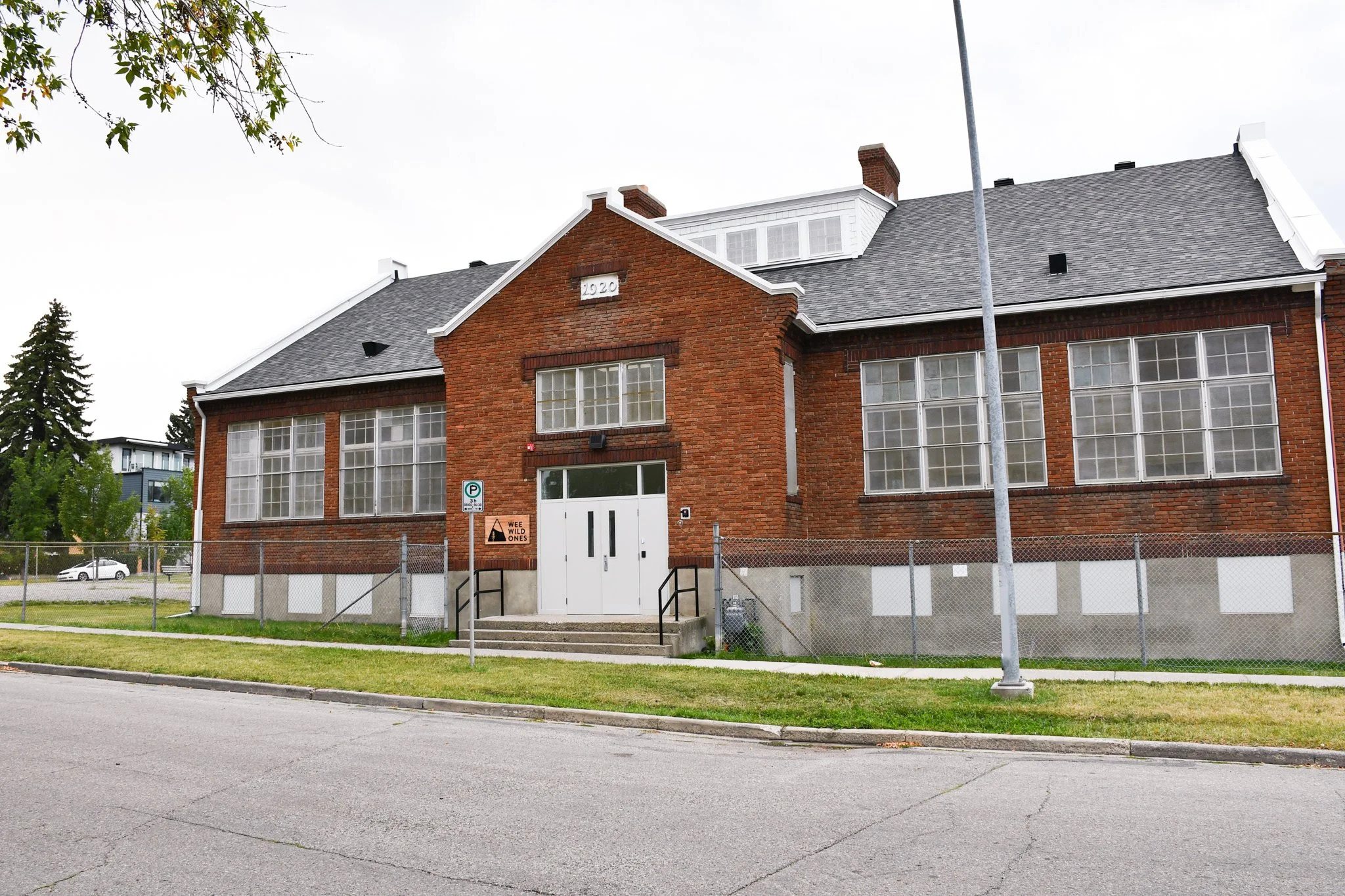 A large brick building featuring a prominent white door at the entrance