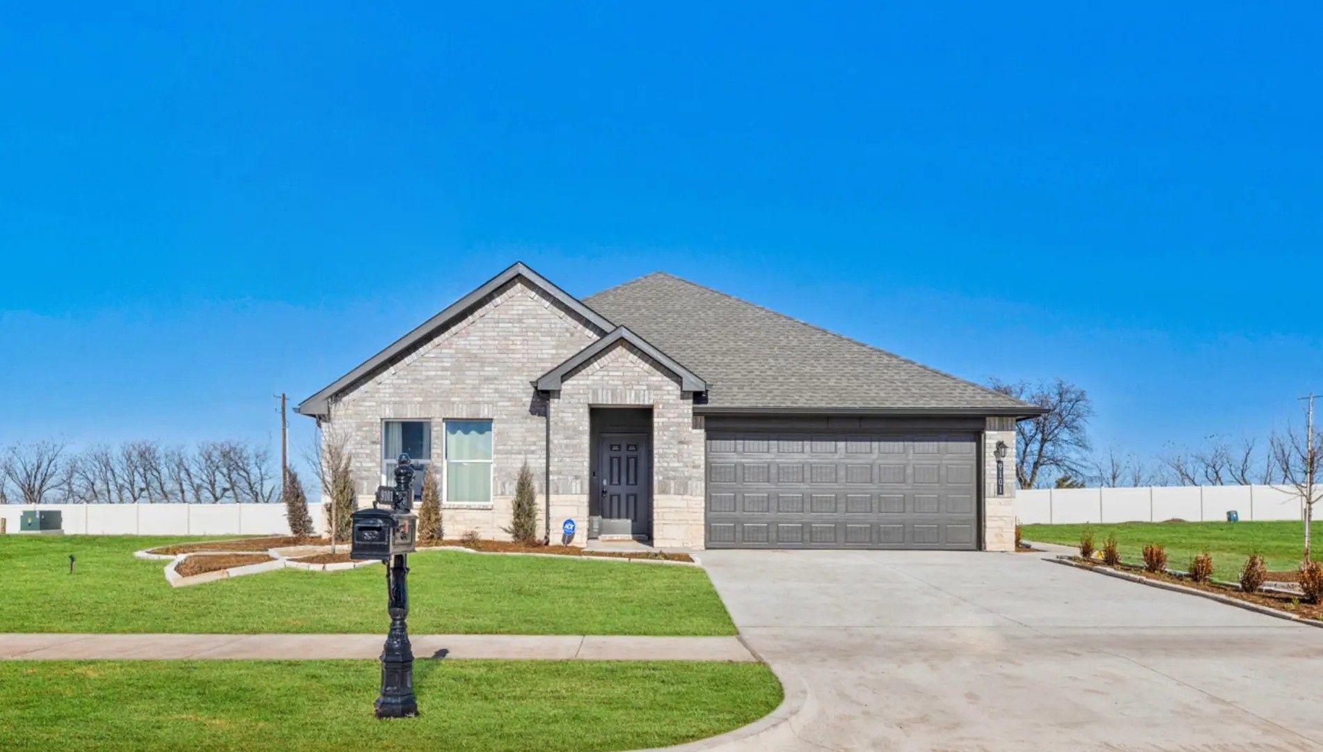 A house with a driveway and a grassy area in front