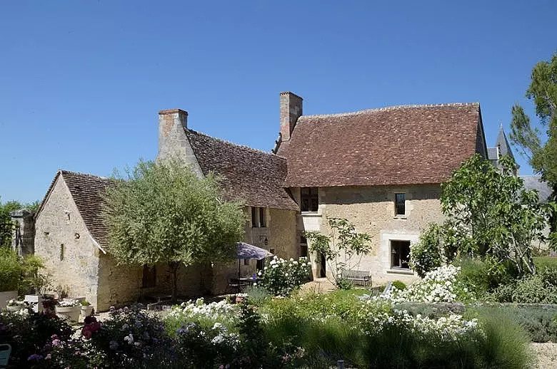 A charming old French country house surrounded by a lush garden
