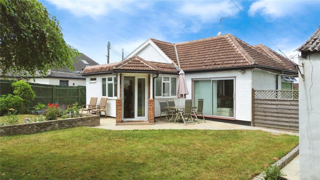 A house surrounded by a lush garden and a well-maintained lawn