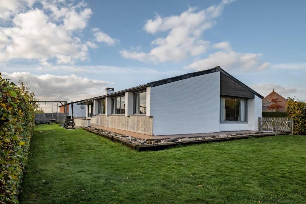 A modern house surrounded by a lush grassy yard